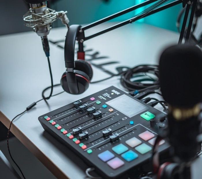 A professional podcasting setup featuring an audio mixer and microphone.