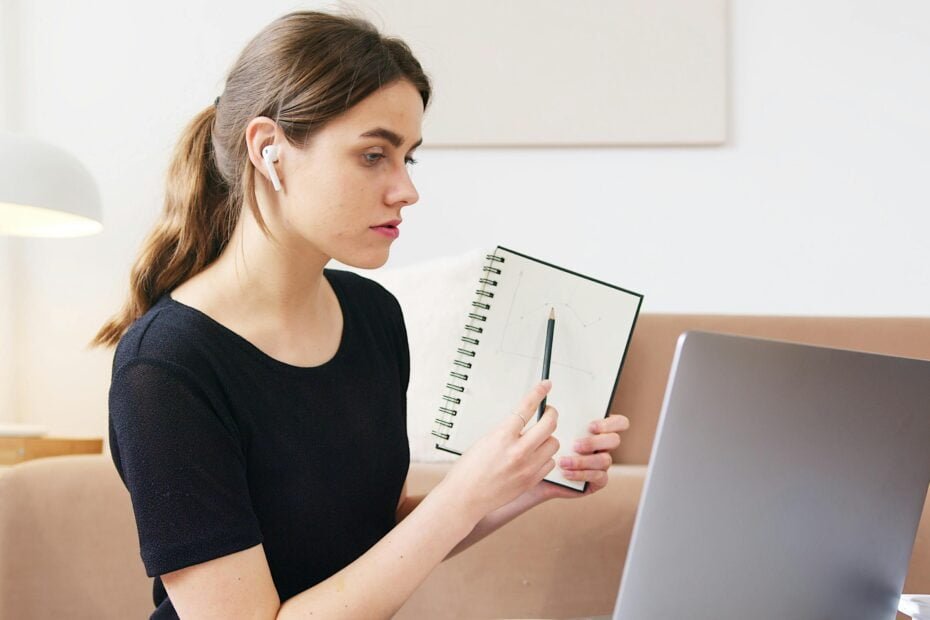 woman taking notes for podcast