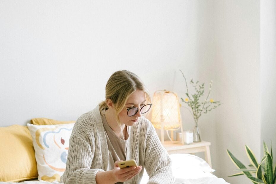 Woman reading notes during a podcast recording session.