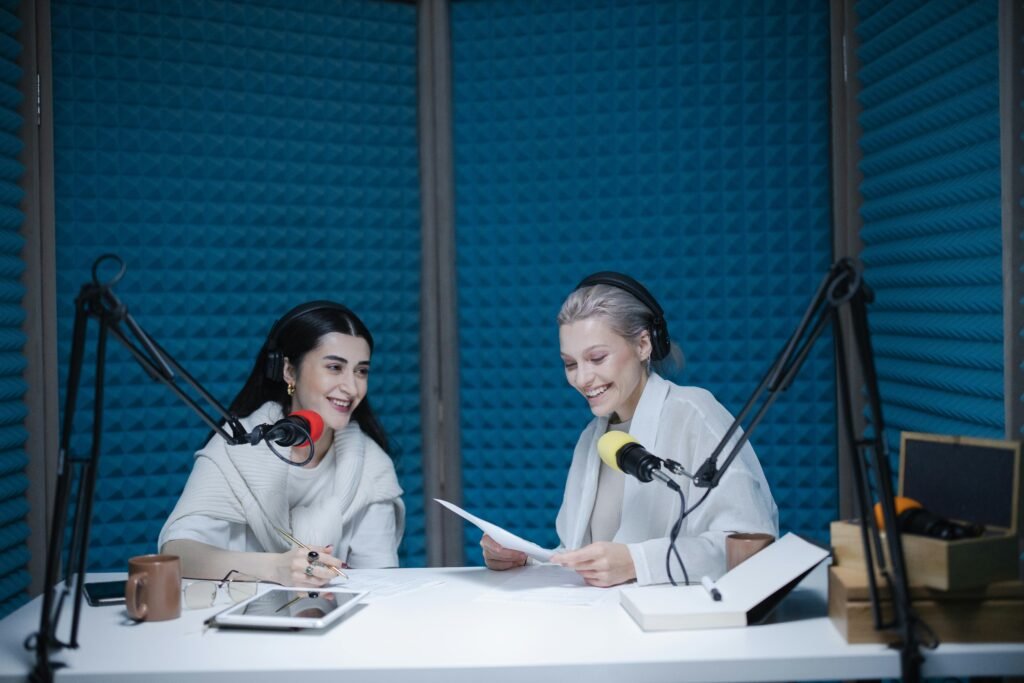 two women co-hosting a podcast episode in a recording studio