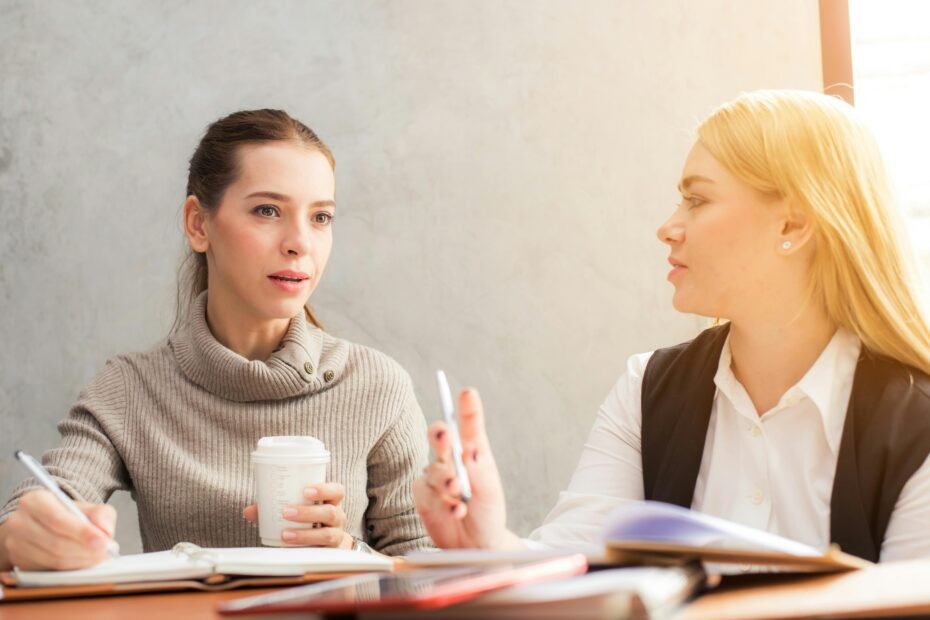 Image of two women having a discussion over coffee