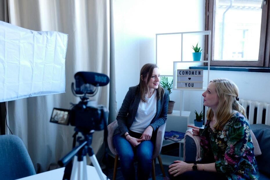 two women recording a video podcast in a bright studio