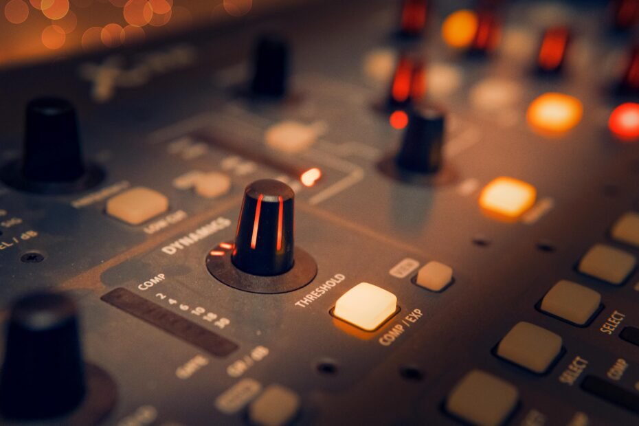 audio mixer with knobs and faders in a recording studio