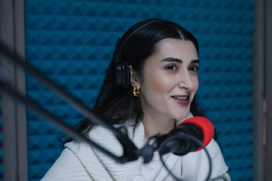 woman speaking into a microphone in a soundproof studio